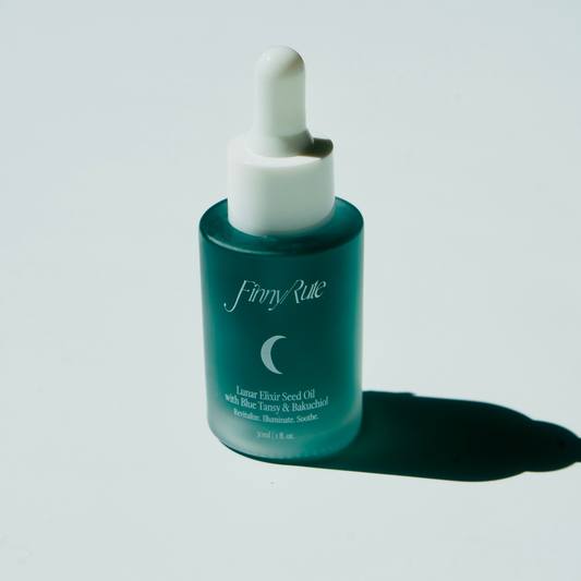 Blue dropper bottle with white cap on a light gray background